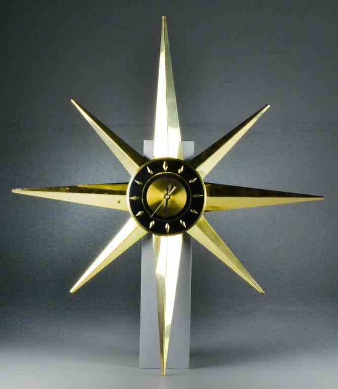 Appraisal: Mid-Century Modern Starburst Brass ClockRadiating brass arms surrounding a black