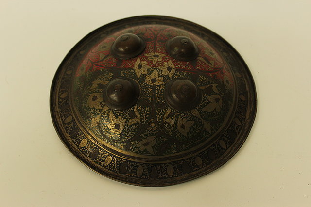 Appraisal: A SMALL CIRCULAR STEEL MIDDLE EASTERN SHIELD engraved with flowers