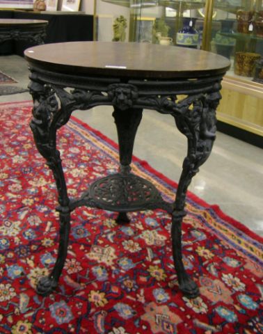 Appraisal: Pair of figural cast iron pub tables with floral design