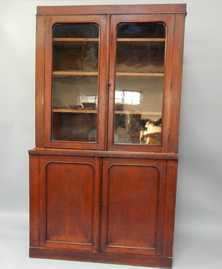 Appraisal: A Victorian mahogany cupboard bookcase with two glazed doors enclosing