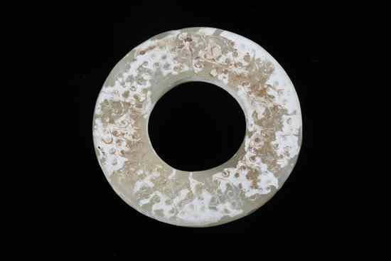 Appraisal: CHINESE CALCIFIED JADE BI Han Dynasty Carved with bosses -