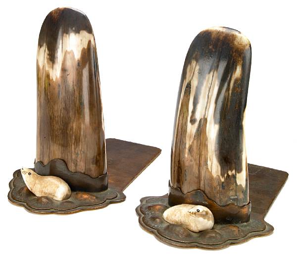 Appraisal: A pair of Albert Berry hammered copper and fossilized walrus