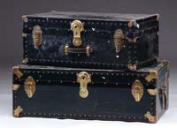 Appraisal: TWO BLACK STORAGE TRUNKS Both with leather handles and metal