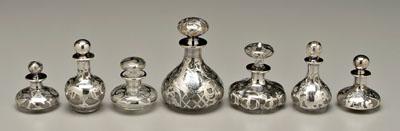 Appraisal: Seven silver overlay perfumes all clear glass largest with three-initial