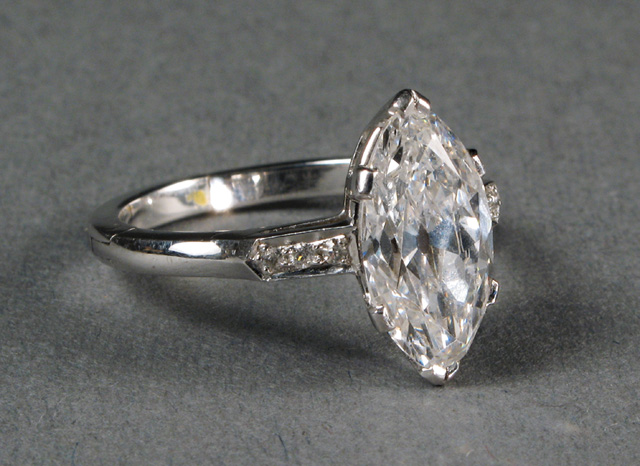 Appraisal: DIAMOND AND FOURTEEN KARAT GOLD RING centering a marquise-cut diamond