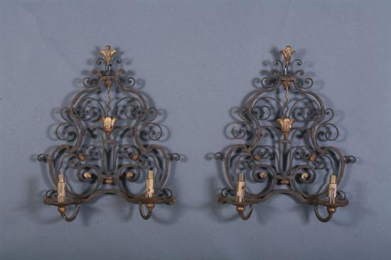 Appraisal: PAIR FRENCH WROUGHT-IRON TWO-LIGHT SCONCES early th century Scrolling backplate