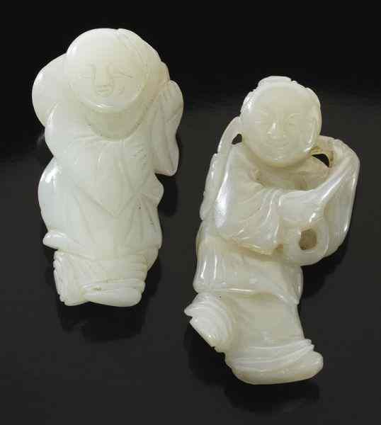 Appraisal: Chinese Qing carved jade boys holding lotus on their backs