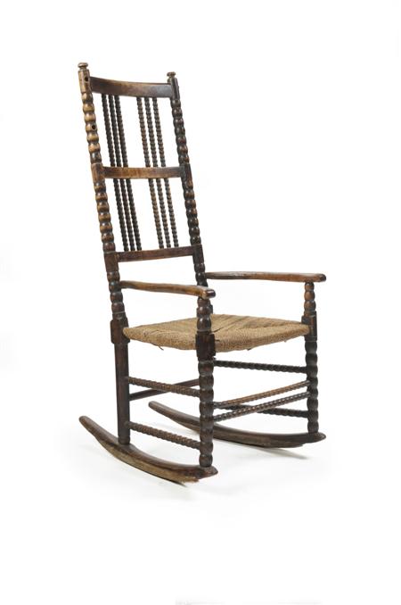 Appraisal: A beech and elm wing rocking chair circa Probably by