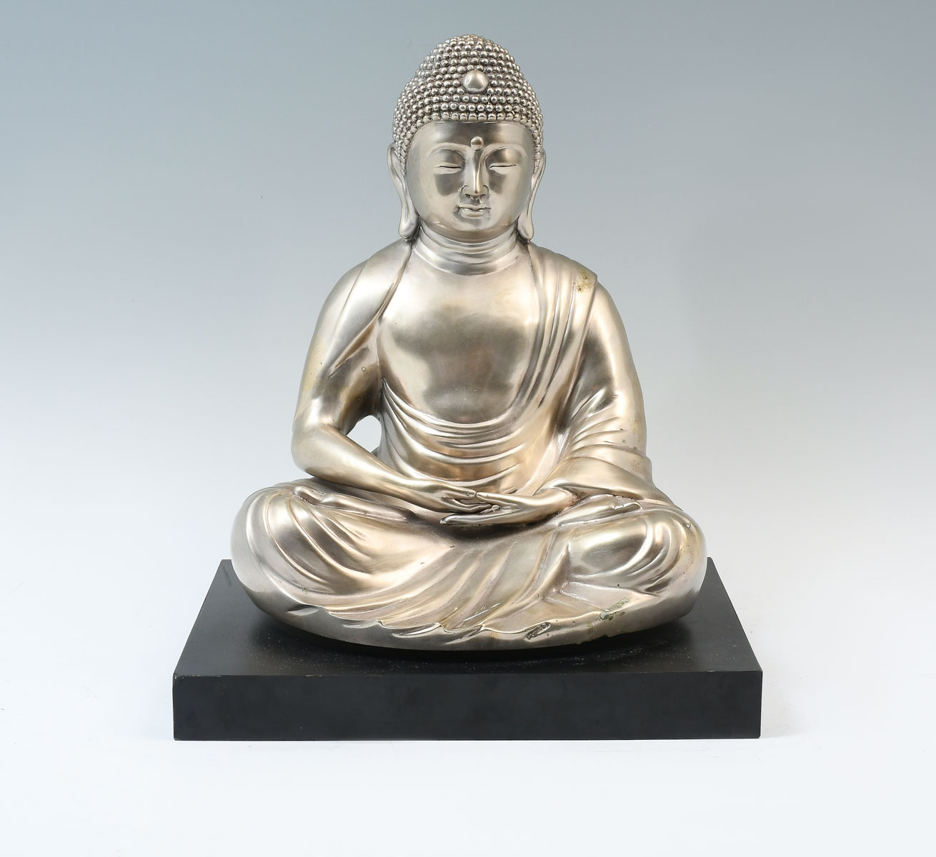 Appraisal: CHINESE TIBETAN SILVERED BRONZE BUDDHA ON BASE Silvered Buddha resting