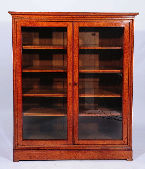 Appraisal: A VICTORIAN BURR WALNUT LIBRARY BOOKCASE the interior fitted four