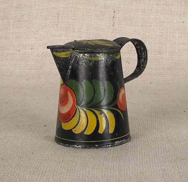 Appraisal: Black tole syrup pitcher th c with polychrome fruit decoration