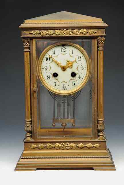 Appraisal: A BRASS FOUR GLASS MANTEL CLOCK the cream enamel Arabic