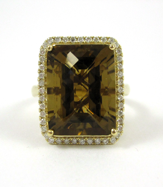 Appraisal: GOLDEN TOPAZ AND FOURTEEN KARAT GOLD RING with round-cut diamonds