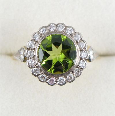 Appraisal: A peridot and diamond cluster ring The circular cut peridot