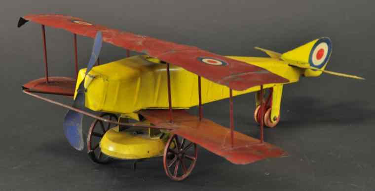 Appraisal: KINGSBURY AIRPLANE Stamped tin bi-plane done in yellow fuselage and