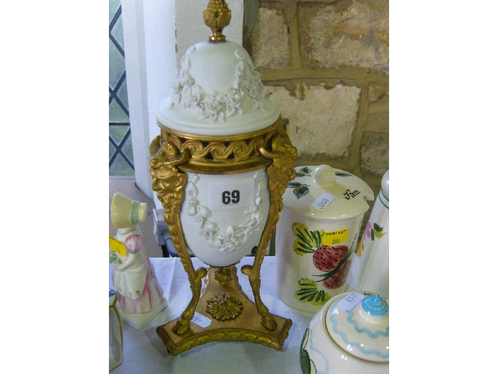 Appraisal: A white biscuit type vase and cover with encrusted floral