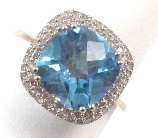 Appraisal: BLUE TOPAZ AND DIAMOND RING k yellow gold featuring a