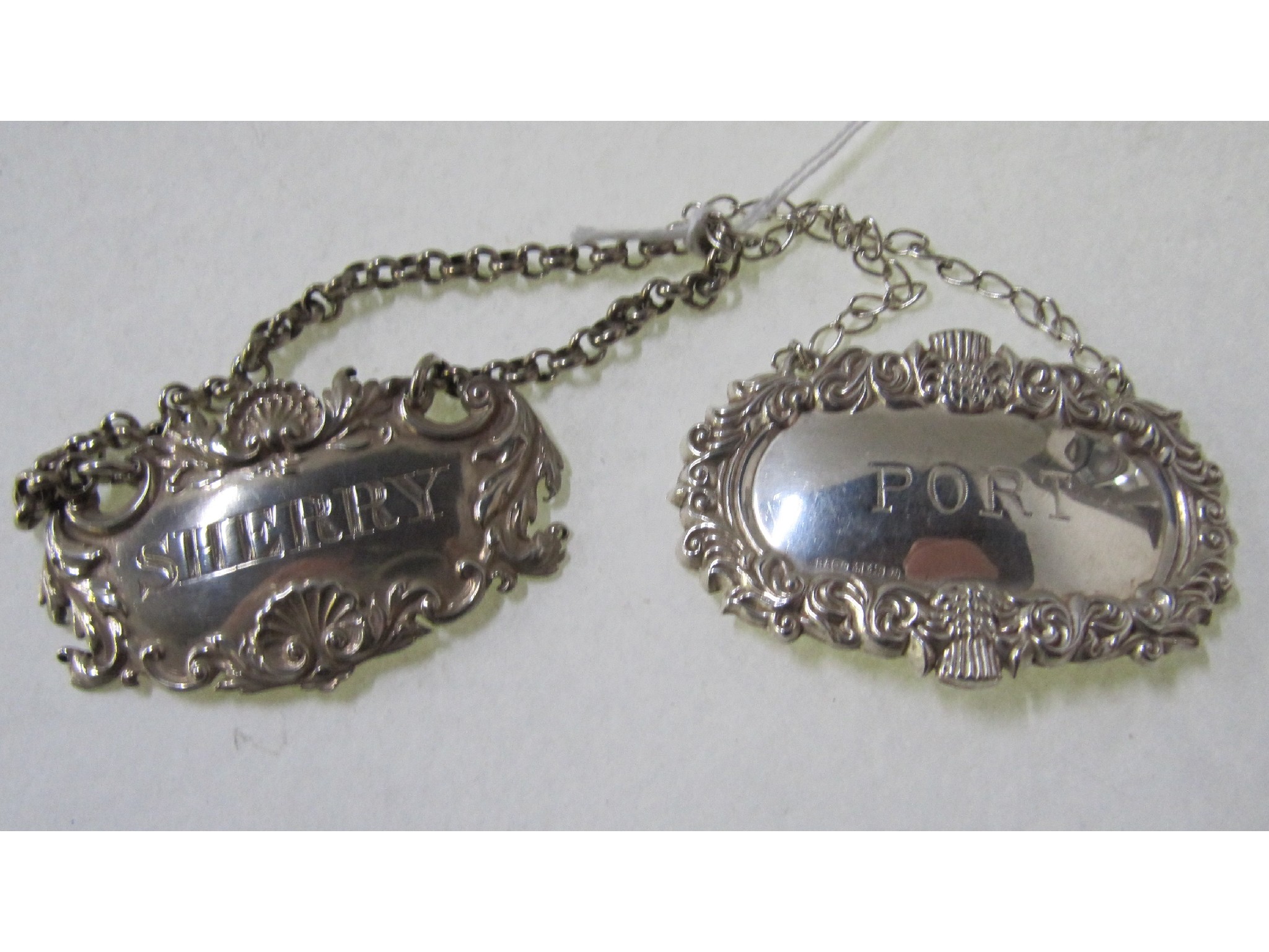 Appraisal: A lot comprising two silver decanter labels London and Birmingham