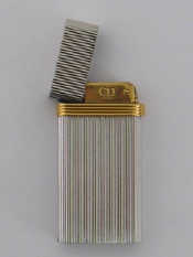 Appraisal: A Christian Dior lighter with gilt metal band mm long