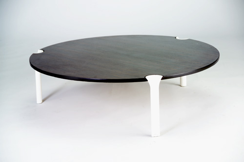 Appraisal: ANDRE MONPOIX Rosewood coffee table with three cast aluminum legs