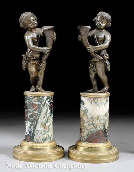 Appraisal: A Pair of Continental Patinated Bronze Figures of Putti Holding