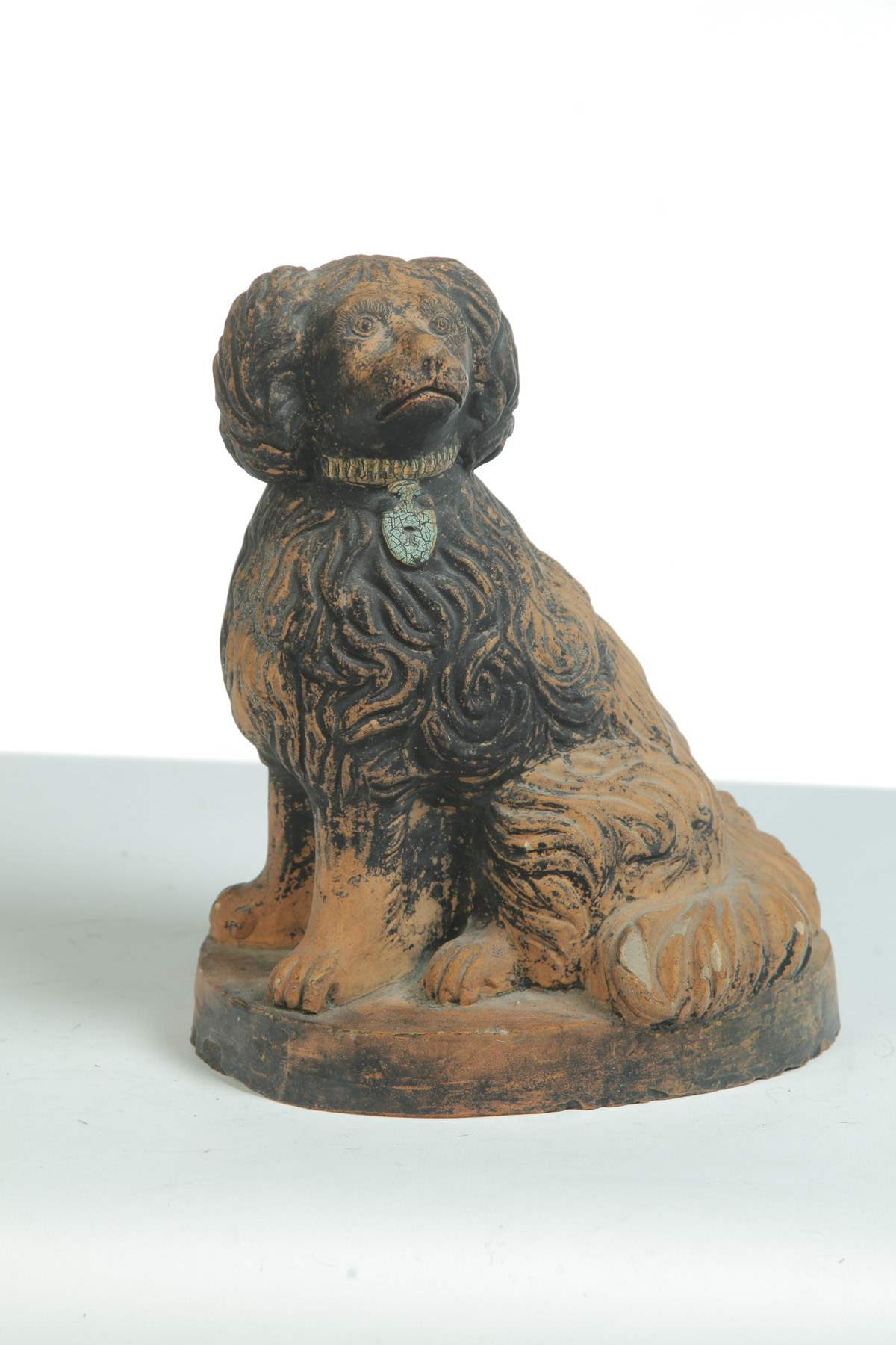 Appraisal: PAINTED YELLOWWARE SPANIEL American ca Seated figure on base with