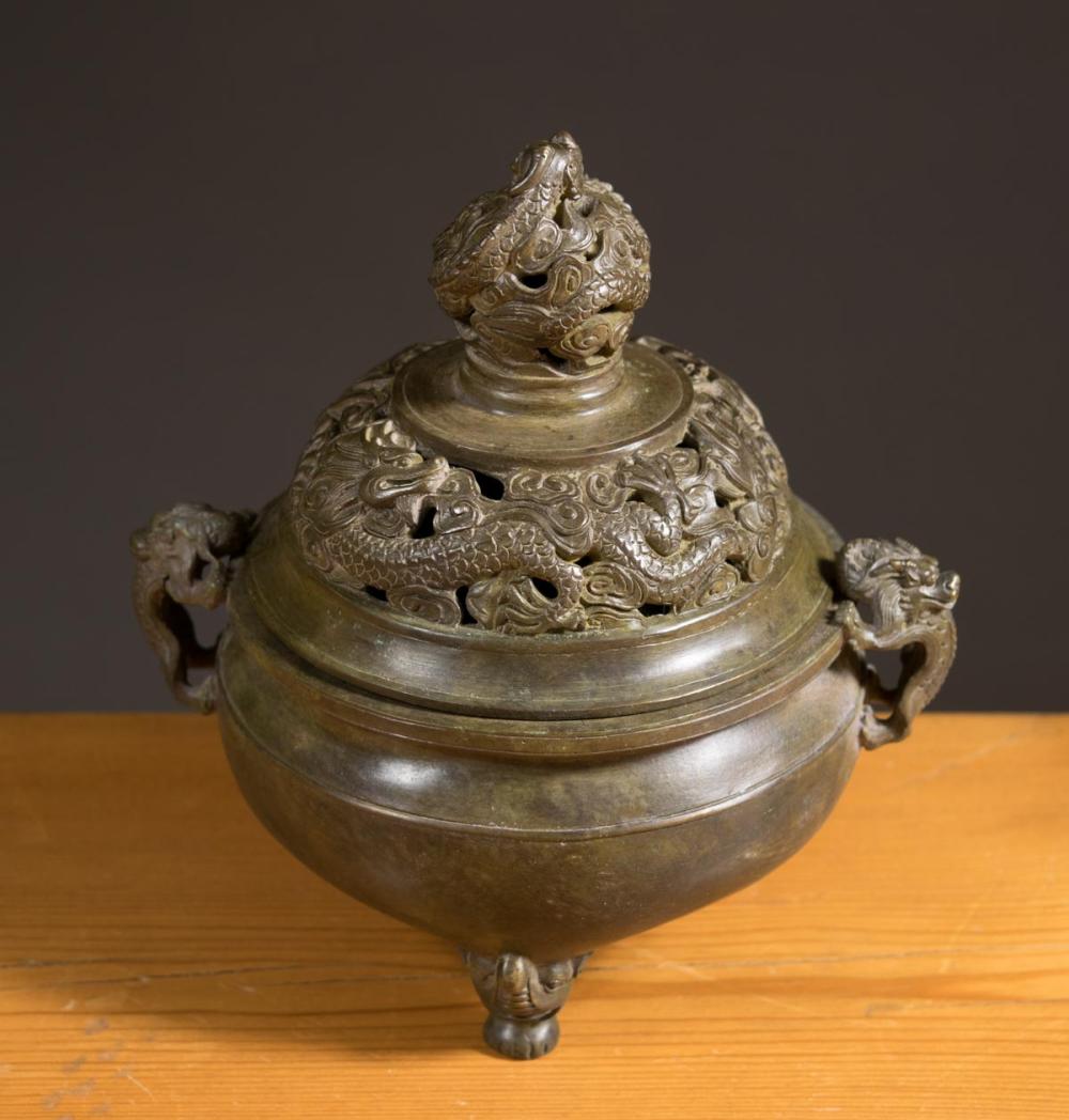 Appraisal: CHINESE BRONZE LIDDED CENSER tri-footed and having squat circular body