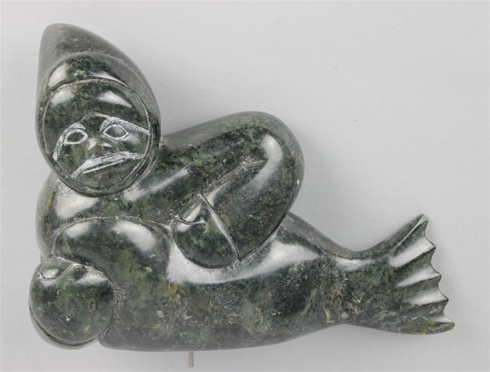 Appraisal: INUIT CARVED STONE OF HUNTER WITH CATCH highly polished surface