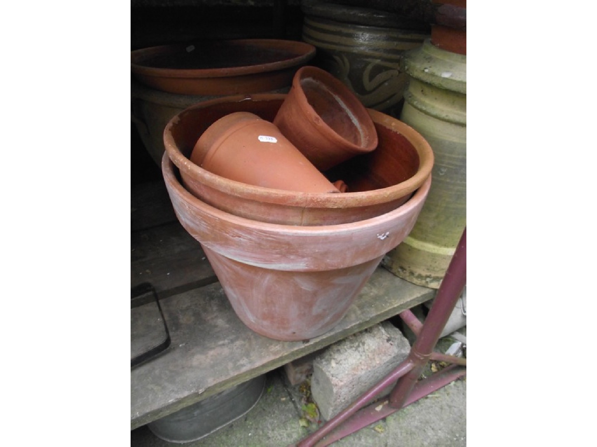 Appraisal: A vintage cast iron tub a reclaimed buff coloured chimney