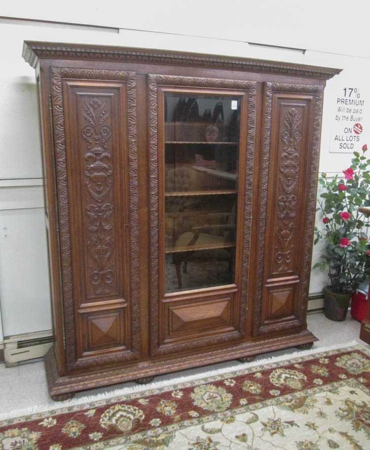 Appraisal: LARGE THREE-DOOR CARVED OAK BOOKCASE German c having a beveled