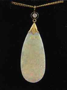 Appraisal: A yellow metal tests gold mounted opal and diamond pendant