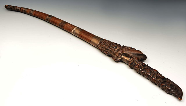 Appraisal: A SOUTH EAST ASIAN CARVED WOODEN DAGGER with steel blade