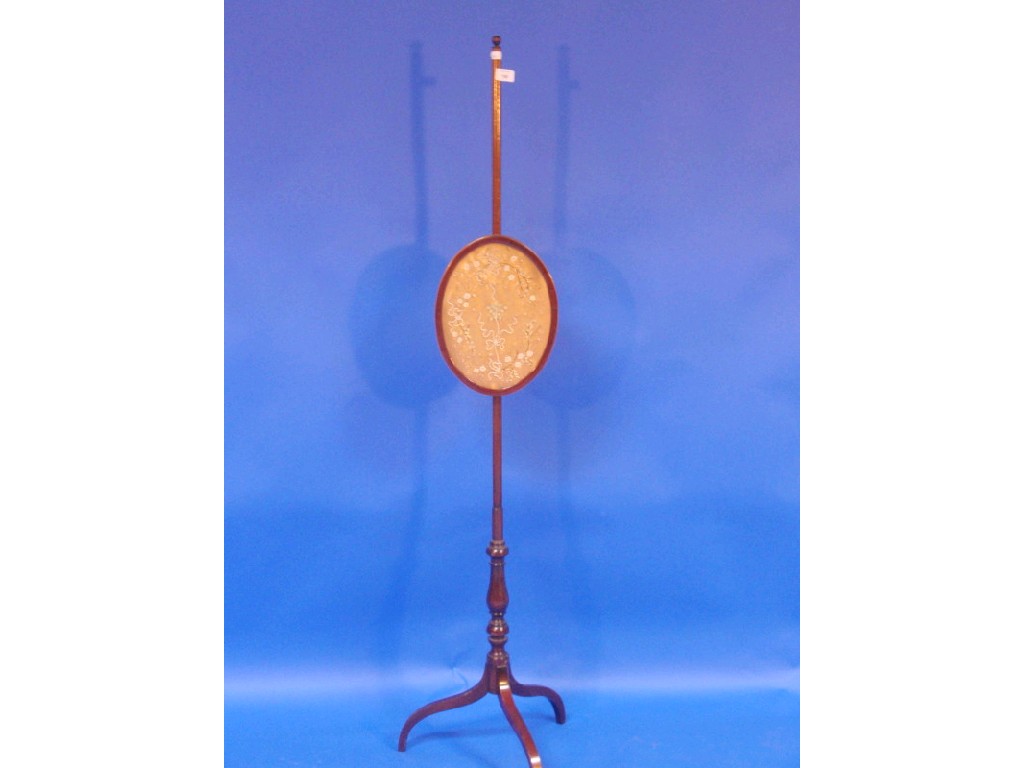 Appraisal: A mahogany pole screen with small oval screen and silk