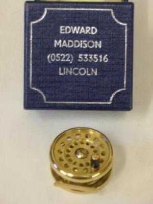 Appraisal: A CT GOLD FISHING REEL by Edward Maddison modelled realistically