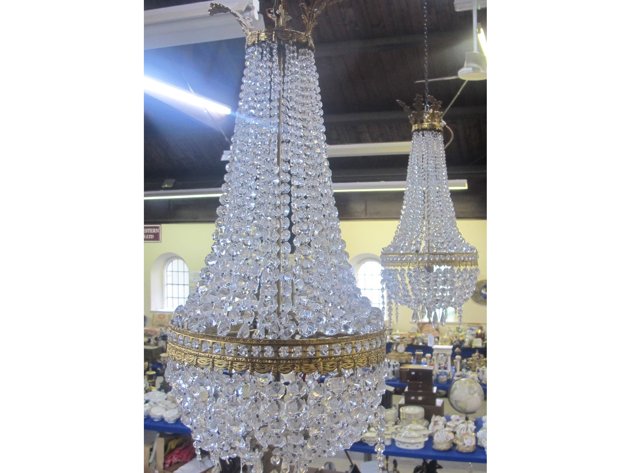 Appraisal: A pair of gilt metal and glass drop chandeliers