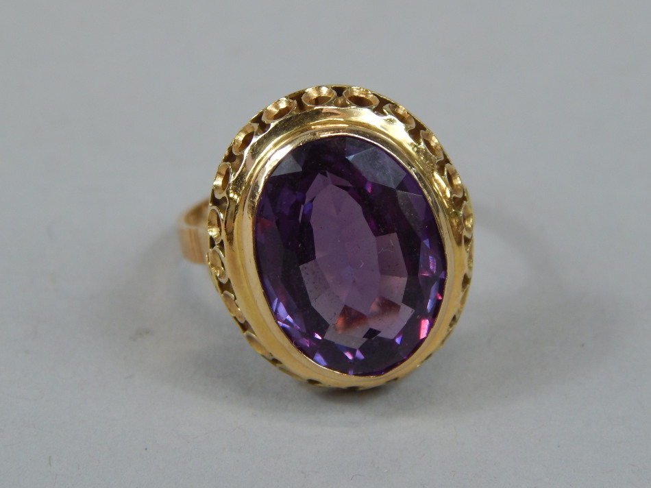 Appraisal: A ladies dress ring of chunky design with oval purple