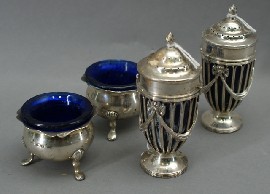 Appraisal: A pair of sterling silver pepper shakers with cobalt glass