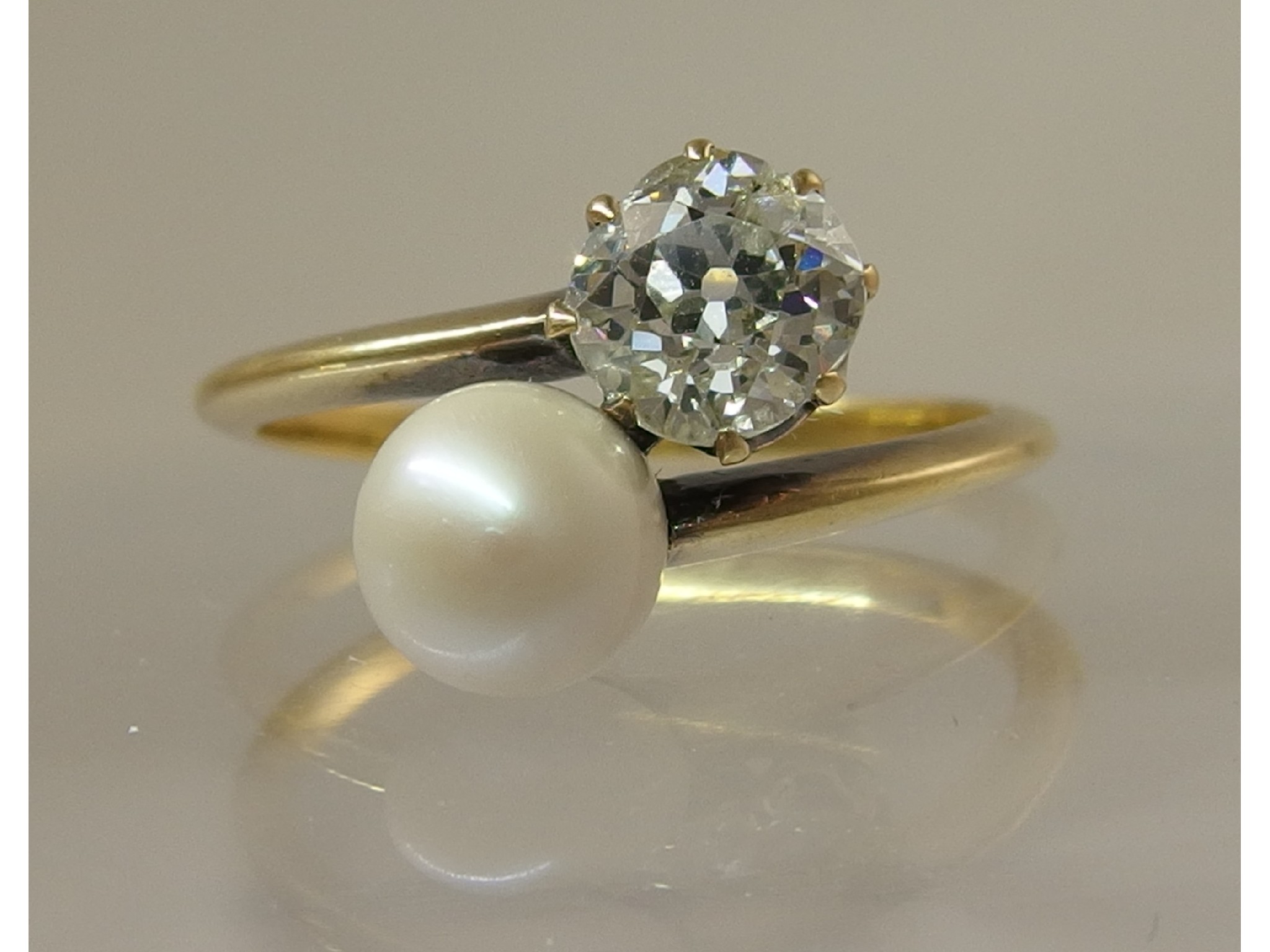 Appraisal: A diamond and natural pearl ringthe cushion cut diamond is