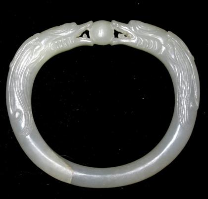 Appraisal: Chinese carved white jade bangleOval form carved to show double