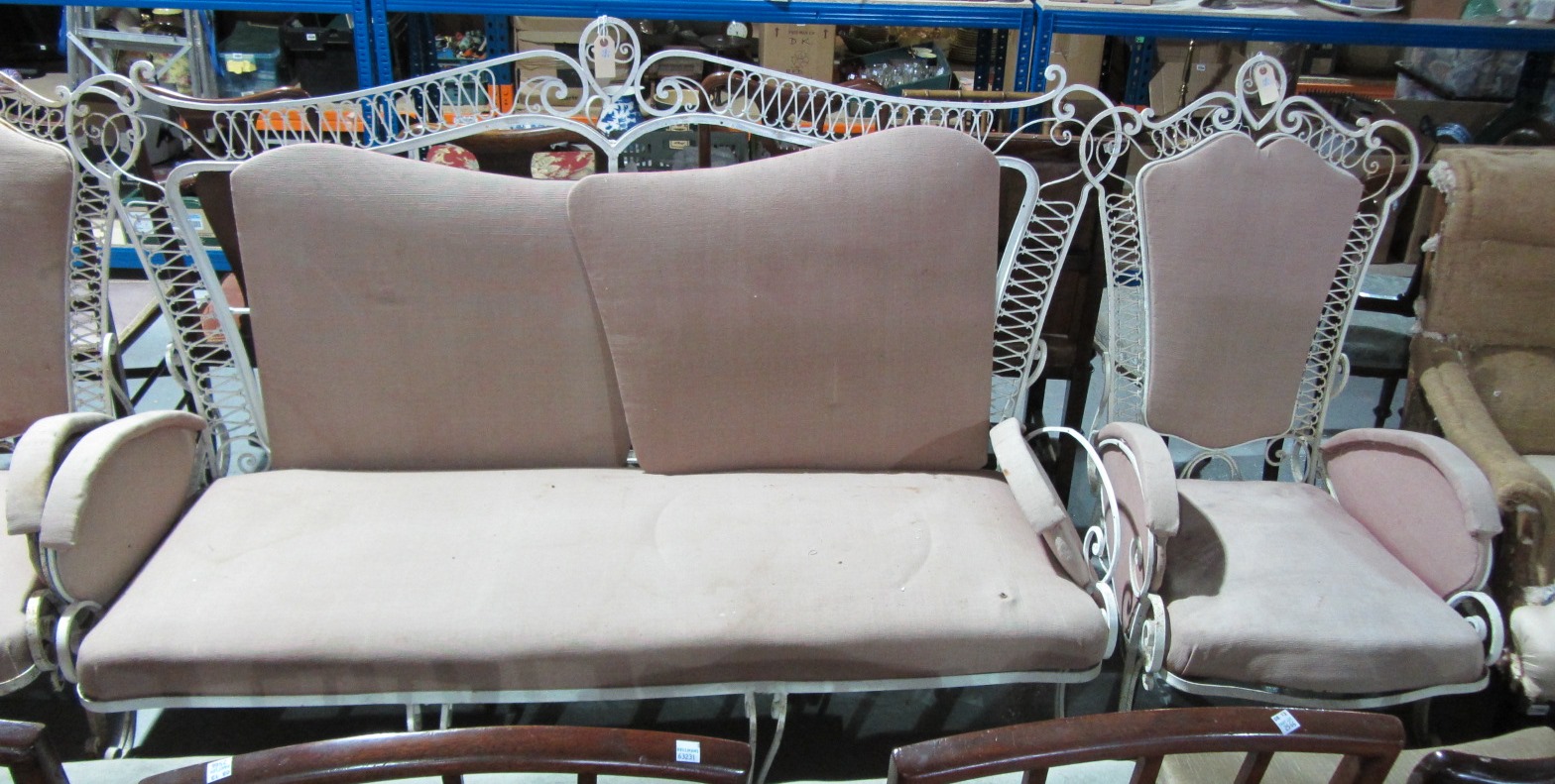 Appraisal: A white painted wrought iron conservatory suite comprising a sofa