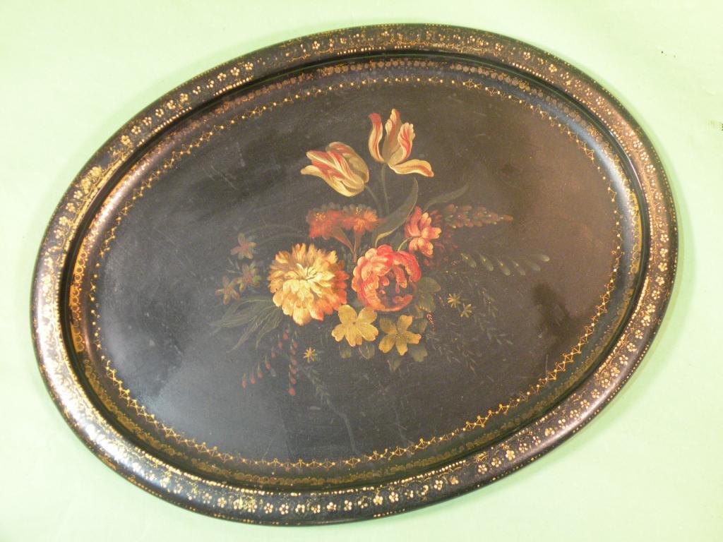 Appraisal: A Victorian oval papier mache tray decorated to the centre