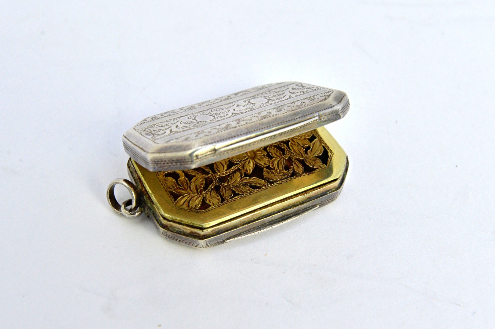 Appraisal: A George III silver cut cornered rectangular vinaigrette with a