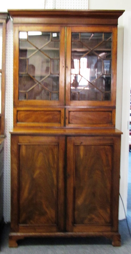 Appraisal: An th century mahogany bookcase cupboard the pair of astragal