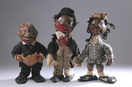 Appraisal: THREE BLACK-FACED PAPIER MACHE DOLLS Circa - Each with exaggerated