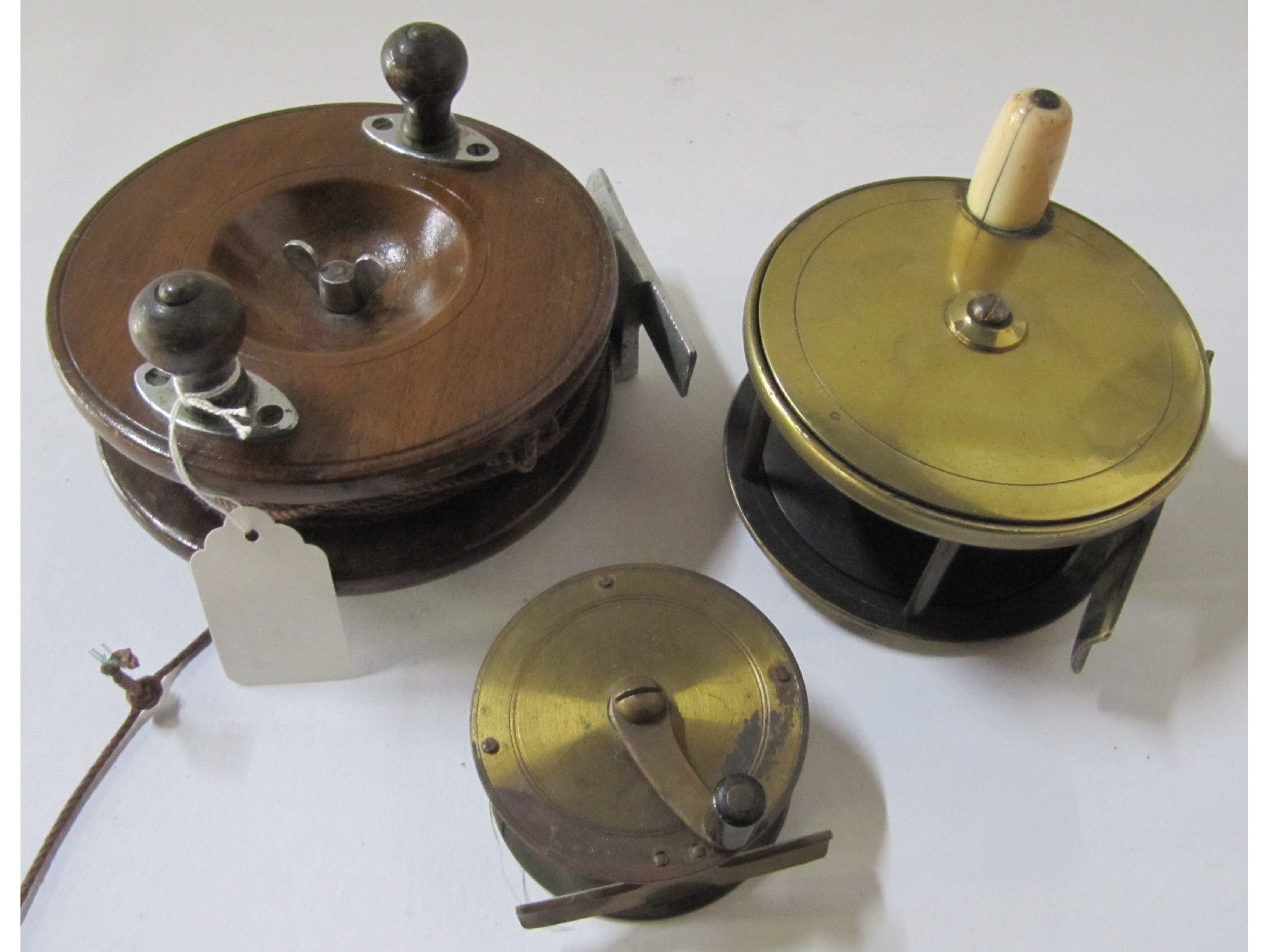 Appraisal: A lot comprising three fishing reels