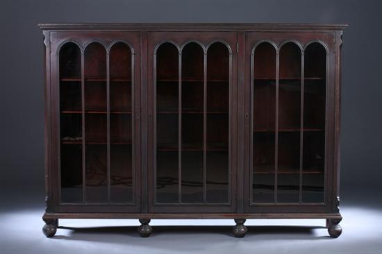 Appraisal: GOTHIC REVIVAL STYLE MAHOGANY BOOKCASE CABINET th century Molded-edge top