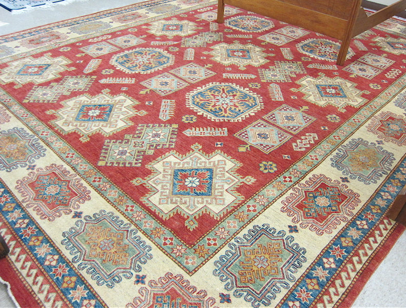 Appraisal: HAND KNOTTED ORIENTAL CARPET Pakistani Caucasian featuring a variety of