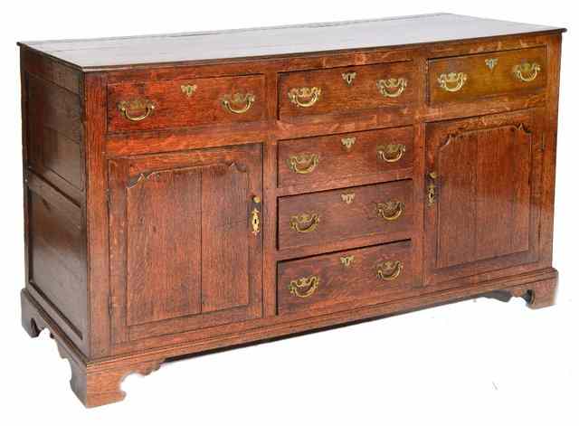 Appraisal: A GEORGE III OAK DRESSER fitted an arrangement of six