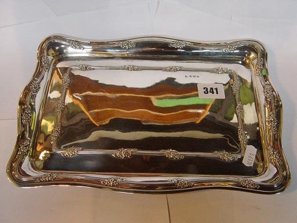 Appraisal: A silver tray of rectangular form with shaped border embossed