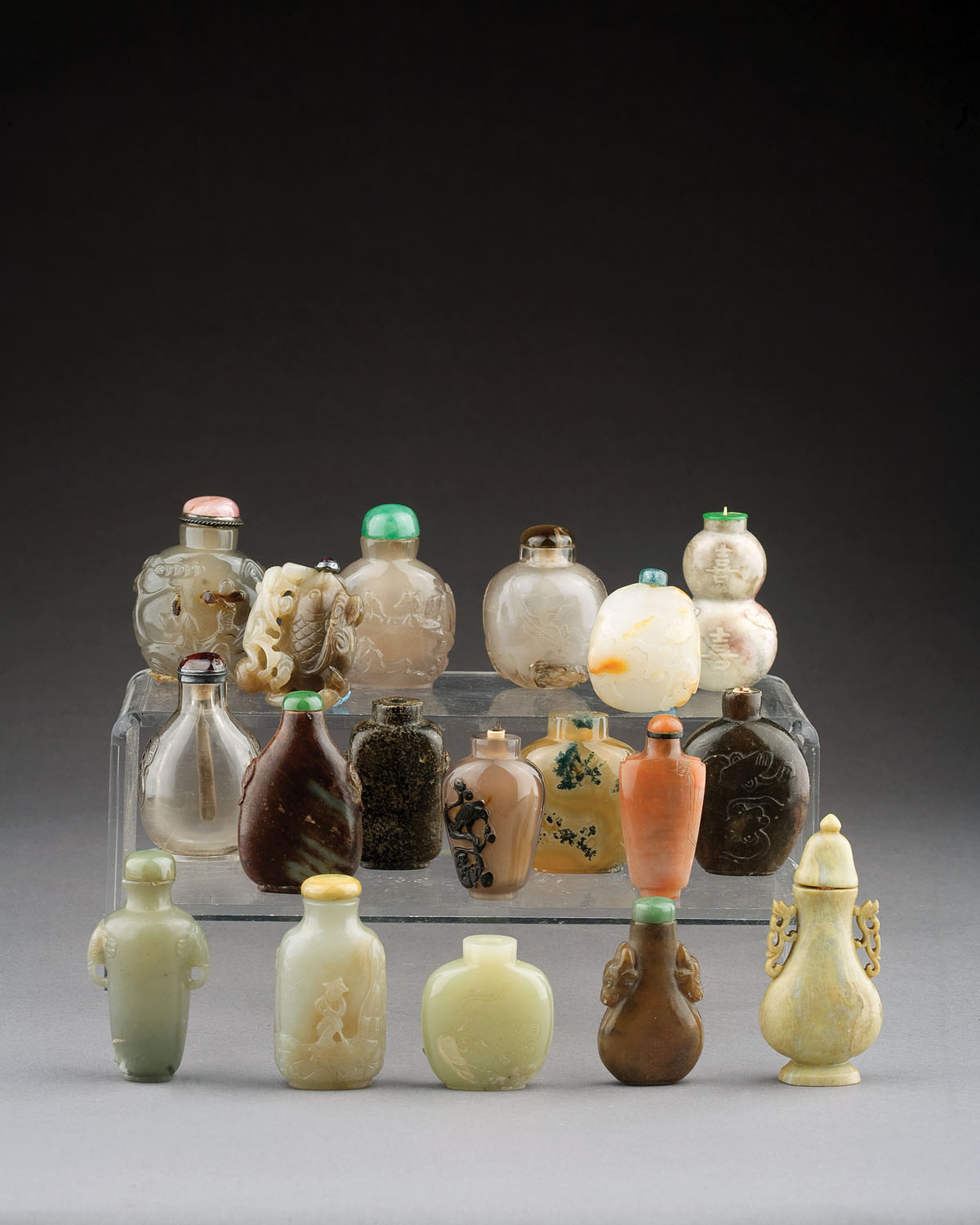 Appraisal: EIGHTEEN CHINESE CARVED HARDSTONE AND GLASS SNUFF BOTTLES Variously carved